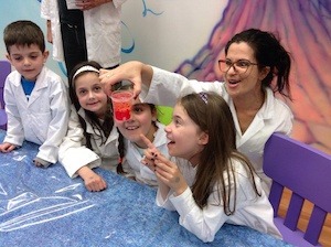 Science-female-teacher-doing-experiment-with-students