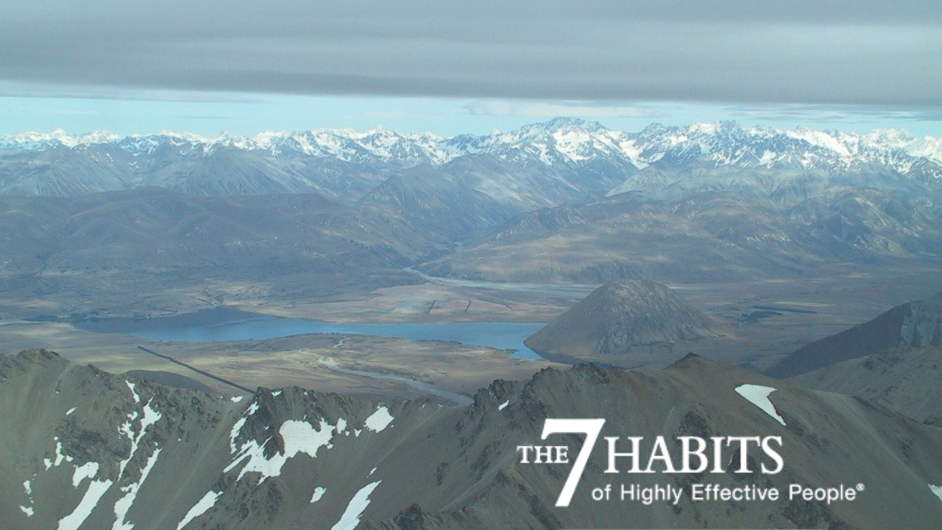 Aerial landscape of mountains, plains and a river running through them